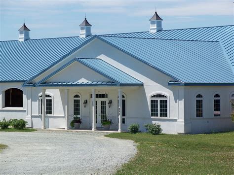 blue house with gray metal roof|houses with blue shingle roofs.